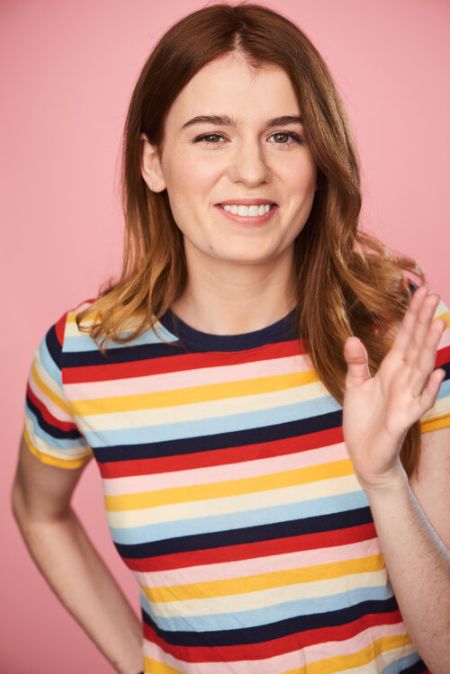 Wylie Anderson in a colourful t-shirt poses for a picture.